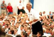 A camper's question brings a smile to the face of Kansas University
basketball coach Roy Williams. The question whether Williams had
coached at the high school level came Tuesday at Horejsi Center.