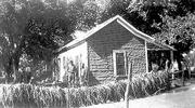 Grapevines along a fence fared slightly better than the home of Leo
and Florence Souders at 634 N. Sixth St., which had to be rebuilt.
The two men near the house were coworkers of Leo Souders at
Lawrence Paper Co.