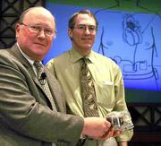 Dr. Laman Gray, left, and Dr. Robert Dowling display an AbioCor
heart at Jewish Hospital in Louisville, Ky. The two implanted the
experimental heart into a patient Monday.