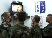 U.S. soldiers, members of the NATO-led peacekeeping troops in
Bosnia, watch a live TV broadcast of former Yugoslav President
Slobodan Milosevic's arraignment before the U.N. War Crimes
Tribunal in The Hague, Netherlands. The soldiers watched the
broadcast Tuesday in the U.S. stabilization force base near the
Bosnian town of Tuzla.