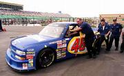 Crew members push Dennis Setzer's truck back to the garage. Setzer
won the pole for today's NASCAR Craftsman Trucks Series O'Reilly
Auto Parts 250 by turning in the fastest qualifying lap Friday at
Kansas Speedway.