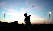Nats right fielder Cody Russell launches the ball into the sky. As
the sun sets and the lights flicker on, the Douglas County 4-H
Fairgrounds baseball diamonds transform into a slice of Americana.