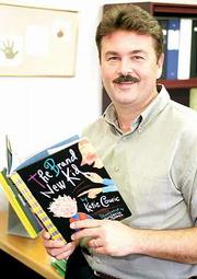 Following a first-day-of-school custom he began in Arizona,
Principal David Williams will read "The Brand New Kid" storybook to
students at Prairie Park School. Williams is also a "new kid" in
Lawrence, having moved from Phoenix in July.