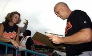 Baltimore's Cal Ripken Jr., seen signing an autograph last month
for Tracy Hodson at Pro Player Stadium in Miami, has fans flocking
to see him. Ripken announced in June that he was going to retire at
the end of the season.