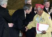 President Bush congratulates Navajo Code Talker John Brown. All 29
original Code Talkers only five are still living were awarded the
Congressional Gold Medal for their heroic service in World War II.