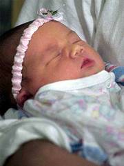 Alexis Michelle Cooper was born this week to a woman who had been
in a coma since she was two weeks pregnant.