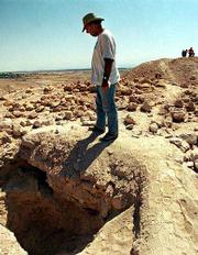 Israeli professor of archaeology Hanan Eshel, of Tel Aviv's Bar
Ilan University, looks at a grave that his team has uncovered at
the West Bank archaeological site of Qumran, near the Dead Sea. The
cave yielded a mausoleum that may have housed the body of a
respected early Christian leader.