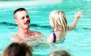 Getting a chance to splash dad is all part of the lesson, and Holly
Swearingen, 3, relishes the moment.