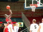 Top CIty's Troy Douglas, of Topeka, rises above his competition
during the quarterfinals of the men's 19-over basketball tournament
at the Sunflower State Games. Top City toppled the Pistols, 77-59,
on Saturday at Allen Fieldhouse.
