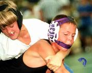 Jordan Brown of Pittsburg loses his mouthpiece as Gardner's Gregory
Curtis makes his move during the Sunflower State Games. Brown
defeated Curtis for third place in the 10-under boys 77-89-pound
wrestling tournament Saturday at Free State High. More SSG coverage
on page 3C.