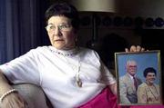 Janice Johnson talks about the death of her husband, D. Carl
Johnson, as she holds a photo of them together at her home in State
College, Pa. After her husband's death, Johnson became more active
at church. She is now a deacon, and got involved with church youth
groups.