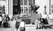 Students take a break between classes near the bronze Jayhawk
statue in front of Strong Hall. Kansas University Provost David
Shulenburger called the past academic year one of "extraordinary
student accomplishment." Students were honored for their
achievements with Mellon fellowships and Truman scholarships.