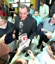 Richard Hatch, the original "Survivor" winner, says he believes
he&squot;s not being treated fairly in his hometown of Middletown, R.I.,
though a judge mostly disagrees. Hatch sued the city&squot;s police
department for releasing arrest information shortly after he
returned to Middletown from "Survivor." Most of the lawsuit was
dismissed this week. Hatch is shown in this September 2000 file
photo surrounded by Middletown residents seeking his autograph.