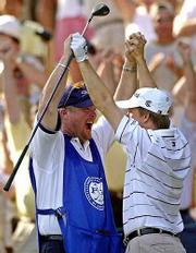 David Toms, right, and caddie Scott Gneiser celebrate after Toms
aced the par-3 15th hole Saturday at Duluth, Ga.