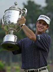 David Toms hoists the walker trophy after winning the PGA
Championship. Toms sank a 12-foot putt on the 18th green to secure
his first major title and deny Phil Mickelson on Sunday in Duluth,
Ga.