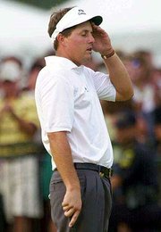 Phil Mickelson rubs his forehead after missing a birdie putt on the
18th hole of the PGA Championship. Mickelson finished second by a
stroke on Sunday.