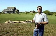 Steven Miles of the Douglas County Appraiser's office looks over a
home south of the Wakarusa River near North 1175 Road. A leading
state transportation offical said Tuesday that 32nd and 42nd street
routes are the leading alignments for completion of the South
Lawrence Trafficway.