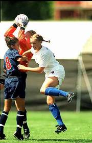Kansas senior forward Natalie Hoogveld, right, collides with an
Illini defender while going for a header. Illini goalkeeper Sarah
Anderson controlled the ball on the play. Illinois won Sunday's
game, 4-3, in overtime at SuperTarget Field.