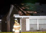 Some residents at the Eudora Nursing Center, 1415 Maple, had to be
moved to a different wing after high winds damaged sections of roof
on the two south wings. At the scene Friday night, a Eudora
firefighter inspects the area outside the damaged building. At the
upper left, damaged brick walls can be seen leaning into the
building.