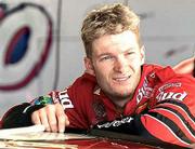 Nascar Driver Dale Earnhardt Jr. listens to his crew in the garage
at Kansas Speedway. Earnhardt was one of several drivers on hand to
test their cars Monday for the upcoming Winston Cup race on Sept.
30.
