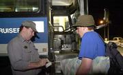 Greyhound bus driver James Balderson, left, marks the ticket of
Wyatt Rogers, Lawrence. Rogers, who is traveling for the first time
by bus, said he had originally planned travel Wednesday flying by
plane, but instead he wound up at the Lawrence Greyhound Bus
Station, 2447 W. Sixth.