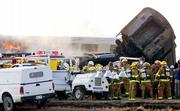 Flames and smoke shoot out the window of a car of an Amtrak
passenger train, left, after it collided with a freight train east
of Wendover, Utah. No serious injuries were reported in Thursday's
crash.