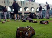 A baseball glove lies in the grass at Enron Field while the San
Francisco Giants stretch. San Francisco's game Thursday at Houston
was postponed because of the national tragedy. Baseball won't
resume play until Monday.
