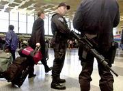Massachusetts State Police troopers armed with automatic weapons
patrol the terminal at Logan International Airport in Boston.
Logan, where two of Tuesday's hijacked flights originated, reopened
Saturday with increased security in the aftermath of the terrorist
attacks on U.S. targets.