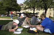 Douglas County will gain representation at the Statehouse after
reapportionment because Kansas University officials failed to
properly count students. From left, sophomore John Holmen, St.
Paul, Minn., senior Mike Schmitz, Holton, and junior Brett Olson,
Chanute, work on an assignment for a communications course that met
outside Friday.