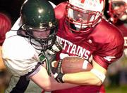 Tonganoxie's Matt Alexander, right, tries to shed a DeSoto
defender. The Chieftains won, 23-20, on Friday night in Tonganoxie.
