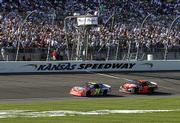 Jeff Gordon (24) leads Ricky Rudd (28) near the end of the
Protection One 400. Gordon won Sunday at Kansas Speedway in Kansas
City, Kan., while Rudd was third.