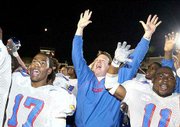 KU COACH TERRY ALLEN, center, celebrates with Mario Kinsey, left,
and Reggie Duncan. The Jayhawks downed Texas Tech, 34-31 in double
overtime, on Saturday in Lubbock, Texas.