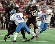 Kansas' Reggie Duncan (11) breaks a long run in the first quarter.
The Jayhawks edged Texas Tech, 34-31 in double overtime, on
Saturday in Lubbock, Texas.