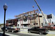 The new three-level Lawrence Arts Center, designed by Glenn
Livingood Penzler and Miller architects of Lawrence, is
40,000-square-foot of brick, glass and metal. The building is set
to open next spring.