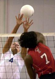 KU'S ABBIE JACOBSON (4) attempts to block Texas Tech hitter Yolanda
Cumbess on Saturday at the Horejsi Center. The Red Raiders won the
Big 12 volleyball match, 30-28, 26-30, 16-30, 30-21, 23-21. The
Jayhawks dipped to 11-5 overall and 2-5 in the conference.