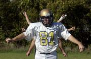 Brandon Hash, No. 81 for the Veritas Eagles, loosens up before
practice with teammates behind him at a field near Community Bible
Church, 906 N. 1464 Road. The Eagles play their final home game of
the season today at the field.