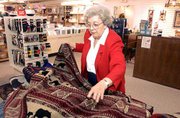 Weavers Department store is hoping that shoppers warm up to
offerings this holiday season at the store, 901 Mass. Weavers
employee Mary Workman stocked shelves Wednesday with blankets,
which are expected to be a hot seller.