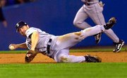 Seattle third baseman David Bell makes a diving throw to first base
after fielding a shot off the bat of Enrique Wilson during the
eighth inning of Game 3 of the ALCS. Wilson was safe at first.