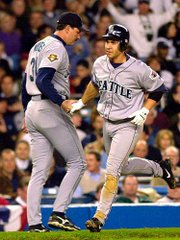Seattle's Bret Boone, right, is congratulated by third base coach
Dave Myers after his homer. The Mariners beat the Yankees on
Saturday at New York.