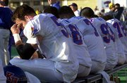 Kansas linebacker Charlie Dennis, left, and the rest of the KU
bench couldn't bear to watch the waning moments of the Sunflower
State Showdown. Kansas State thumped the Jayhawks, 40-6, on
Saturday at KSU Stadium.
