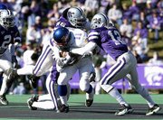 Kansas' Reggie Duncan is pulled down by a trio of K-State
defenders. Duncan finished with 28 yards on 17 carries on Saturday
at KSU Stadium.