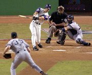 Arizona's Luis Gonzalez connects for a two-run home run against New
York's Mike Mussina. Yankees catcher Jorge Posada, far right, and
umpire Steve Rippley watch the action. The Diamondbacks defeated
the Yankees, 9-1, in the opening game of the World Series on
Saturday night at Bank One Ballpark in Phoenix.