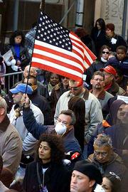 A unidentified man waves a flag during a memorial service Sunday in
New York for the Sept. 11 terrorist attacks on the World Trade
Center.