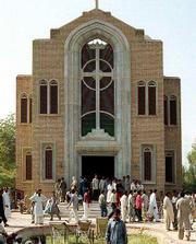 Mourners walk around St. Dominic's Catholic Church in Behawalpur,
Pakistan. Unidentified gunmen killed 16 Christian worshippers
Sunday.