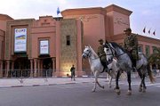 Mounted police pass by the congress hall where the climate summit
will take place this week in Marrakesh, Morocco. This meeting will
be the first major international conference to be held after the
terrorist attacks on America on Sept. 11.