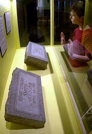 AKyle Sell, 10, of Atchison, looks at the tombstones of killers
Richard Hickock and Perry Smith, while visiting the Kansas Museum
of History in Topeka.