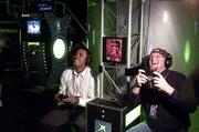 Microsoft's first foray into gaining -- the Xbox -- hits shelves
Thursday. Mark Foxton, left, of San Jose, Calif., and Doug Kennedy
of Twain Harte, Calif., right, play the video game DOA3 at the Xbox
Odyssey in San Francisco.