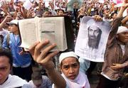 A protester holds up the Quran and a picture of terrorist suspect
Osama bin Laden during an anti-U.S. protest in Jakarta, Indonesia.
The rise of Islamic militancy in the island nation is a threat both
Indonesia's government and to Western countries.