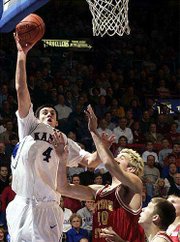Ku's Nick Collison launches a hook shot over Oliver Vogt. Collison
fouled out Wednesday at Allen Fieldhouse.