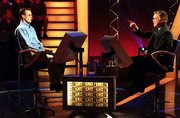 John Carpenter, left, an Internal Revenue Service employee from
Hamden, Conn., sits across the console from Regis Philbin, host of
"Who Wants To Be a Millionaire," during taping of the show in
November 1999. Carpenter was the first million-dollar winner on the
show. ABC executives won't commit to putting "Millionaire" on its
Fall 2002 schedule.